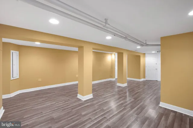 a view of an empty room with wooden floor