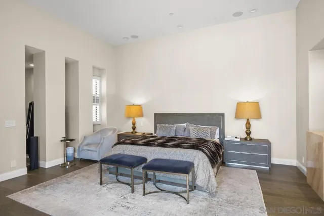 a bedroom with a bed and a lamp