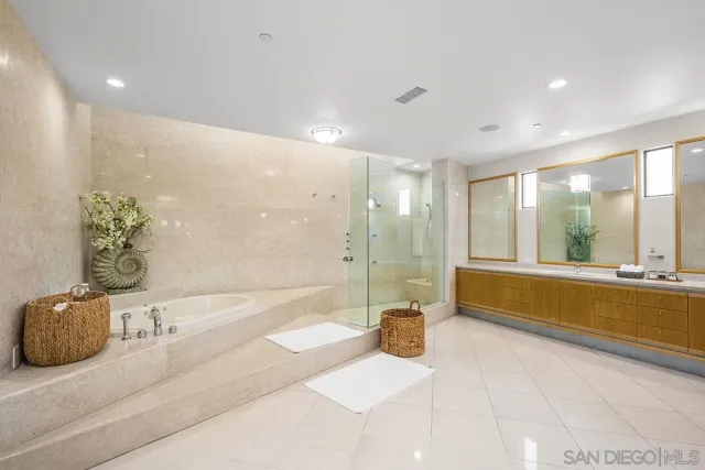 a bathroom with a tub a sink and a shower