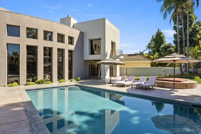 a view of a patio with swimming pool table and chairs