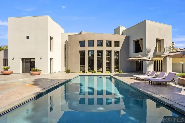 a view of residential houses with cars