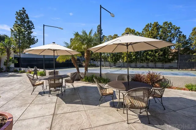 a patio with a patio table and chairs