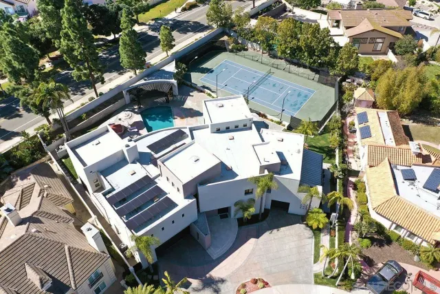 an aerial view of a house with outdoor space and parking