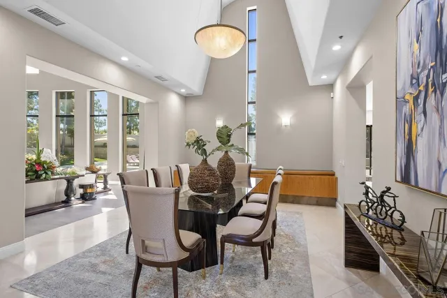 a dining room with furniture and wooden floor
