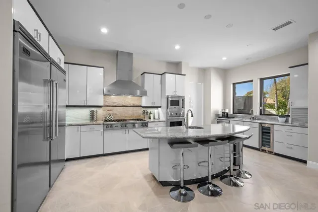 a kitchen with cabinets and refrigerator