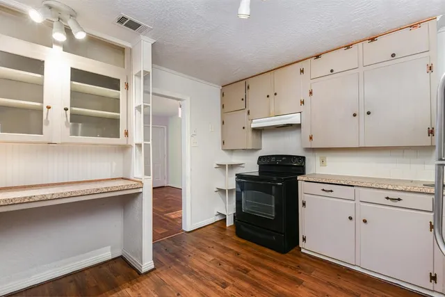 a kitchen with stainless steel appliances granite countertop a stove and a refrigerator