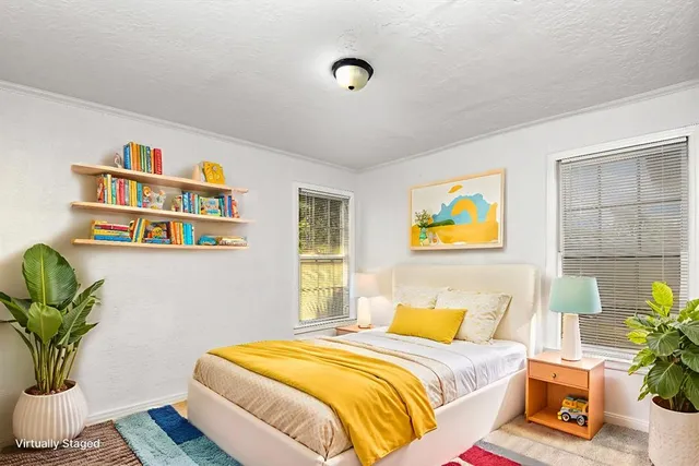 a bedroom with a bed and a potted plant