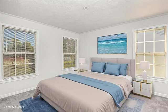 a bedroom with a large bed and a window