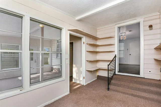 a view of a room with a furniture and front door