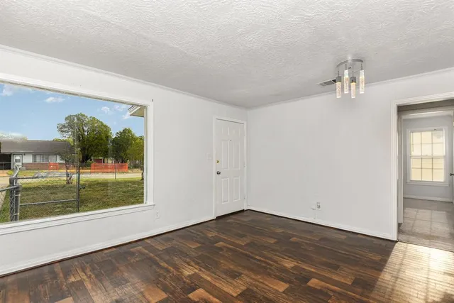 wooden floor in an empty room with a window