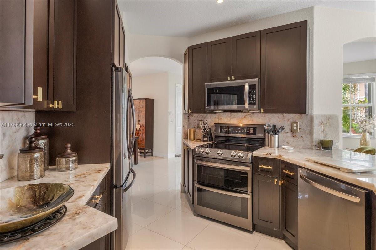 12367 Southwest 122nd Street Miami, FL 33186 - Photo 12 of 35 a kitchen with a stove and a microwave