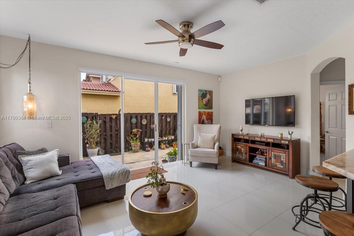 12367 Southwest 122nd Street Miami, FL 33186 - Photo 15 of 35 a living room with furniture and a flat screen tv