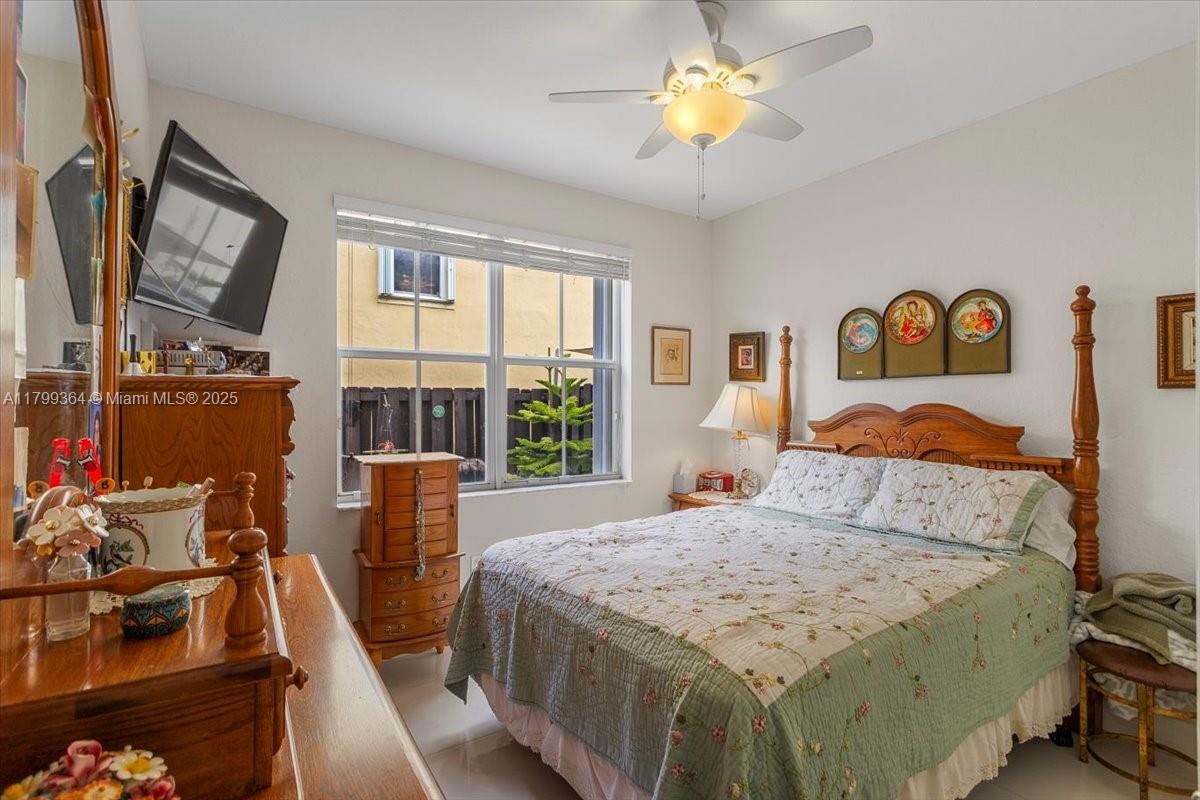 12367 Southwest 122nd Street Miami, FL 33186 - Photo 16 of 35 a bedroom with a bed and a chandelier