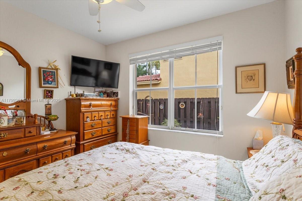12367 Southwest 122nd Street Miami, FL 33186 - Photo 17 of 35 a bedroom with furniture window and flat screen tv