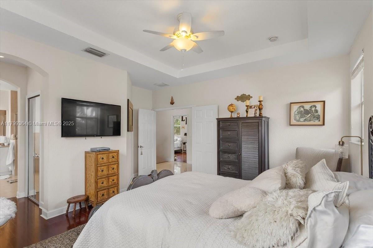 12367 Southwest 122nd Street Miami, FL 33186 - Photo 21 of 35 a bedroom with a bed and a flat screen tv