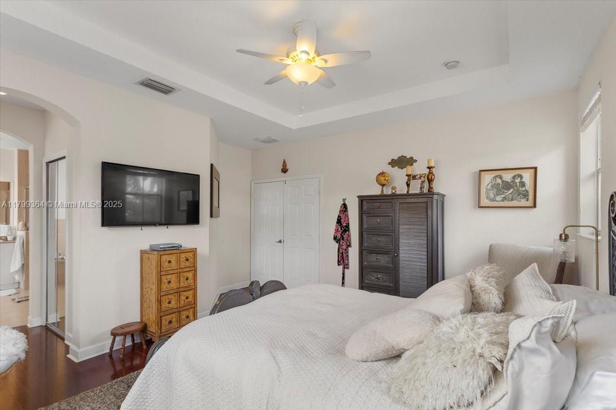 12367 Southwest 122nd Street Miami, FL 33186 - Photo 22 of 35 a bedroom with a bed and a flat screen tv