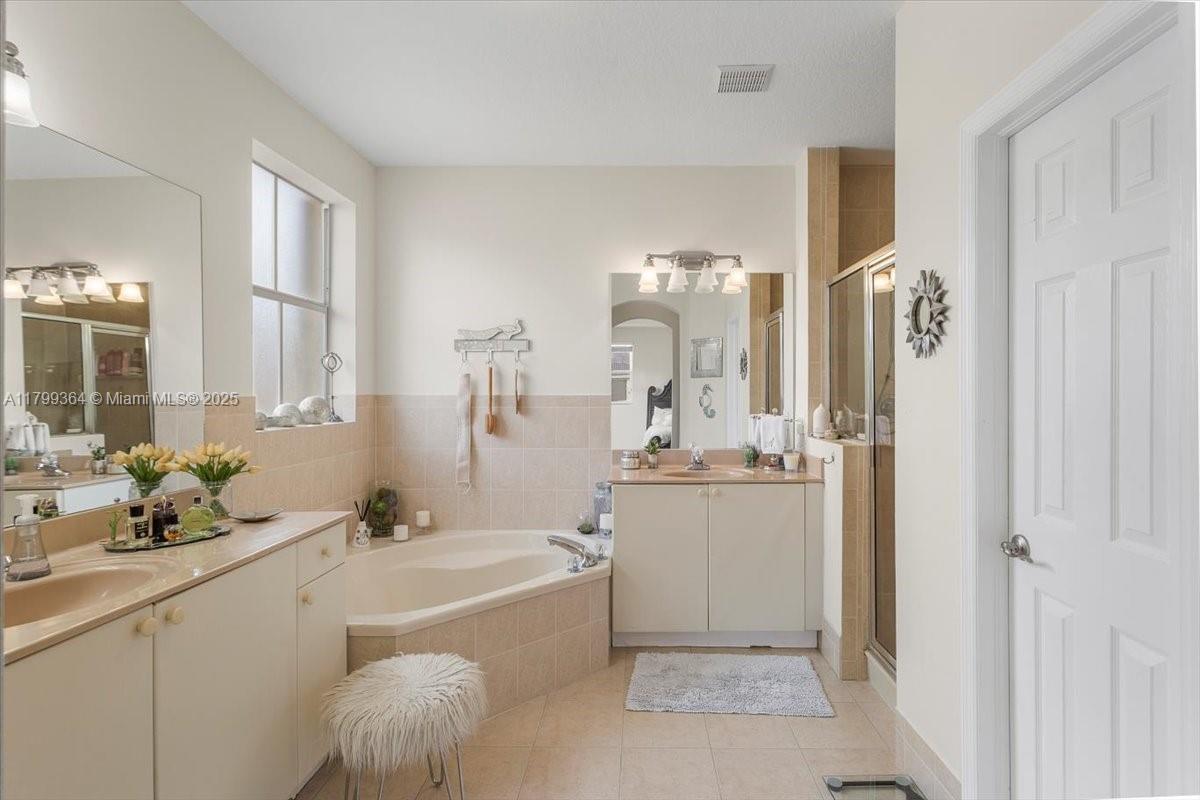 12367 Southwest 122nd Street Miami, FL 33186 - Photo 24 of 35 a bathroom with a tub sink and mirror