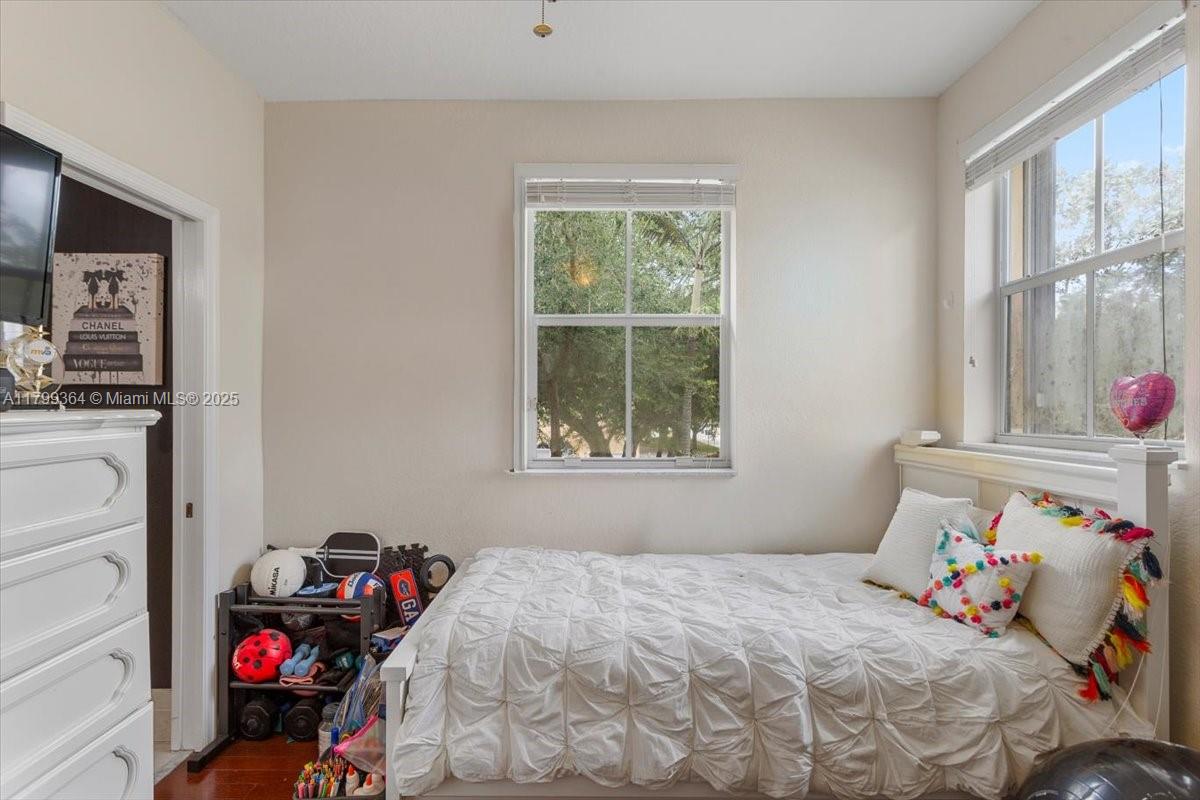 12367 Southwest 122nd Street Miami, FL 33186 - Photo 27 of 35 a bedroom with a bed and a window