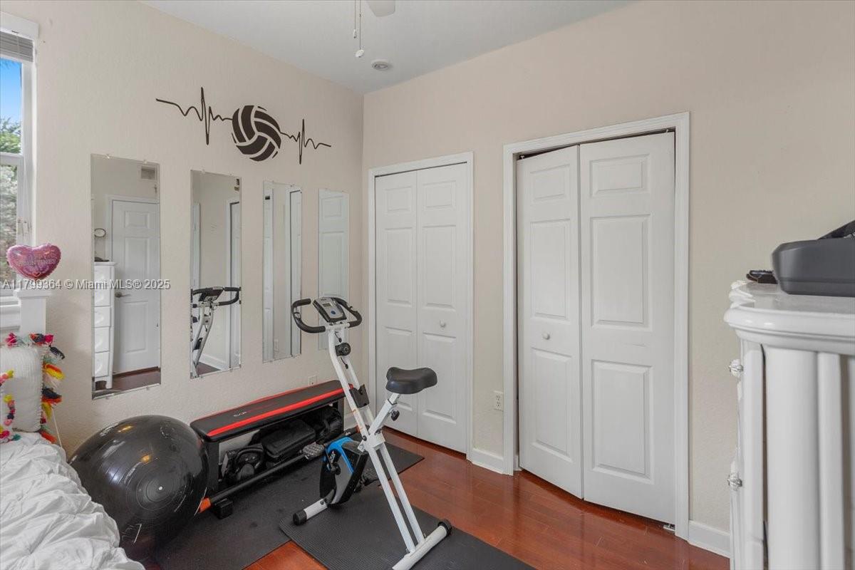 12367 Southwest 122nd Street Miami, FL 33186 - Photo 28 of 35 a room with furniture a mirror and a wooden floor
