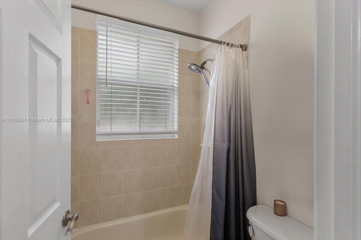 12367 Southwest 122nd Street Miami, FL 33186 - Photo 29 of 35 a bathroom with a tub a sink and a window