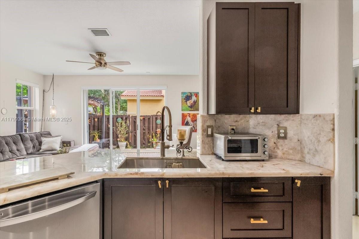 12367 Southwest 122nd Street Miami, FL 33186 - Photo 10 of 35 a kitchen with stainless steel appliances granite countertop a sink and a microwave