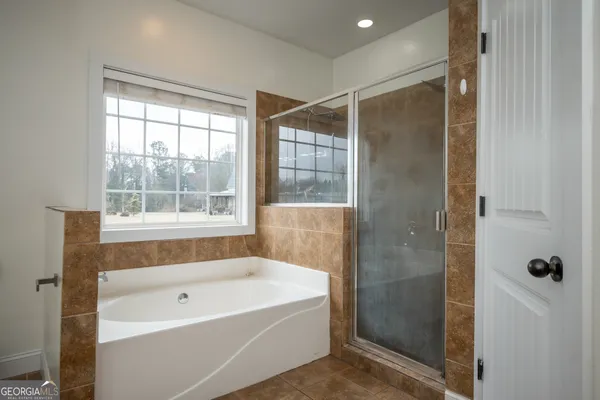 a bathroom with a bathtub and shower