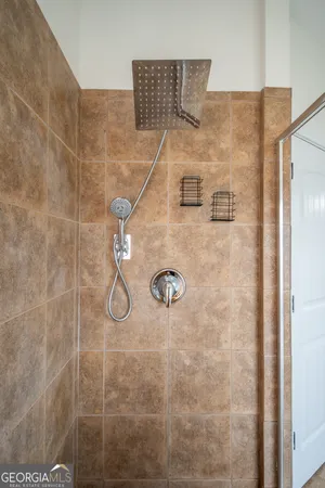 a white bath tub sitting in a bathroom next to a window