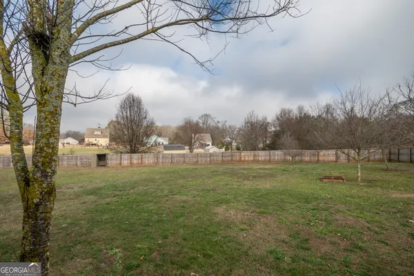 a view of outdoor space with green field and trees