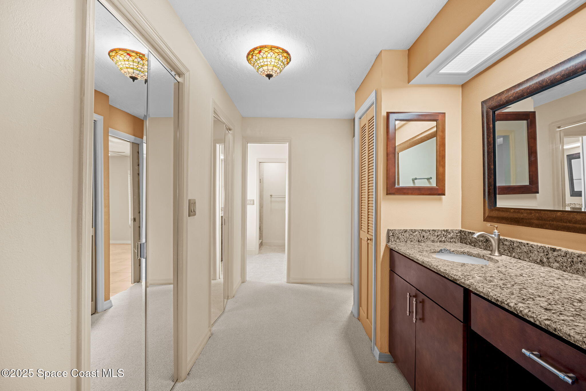 1940 Gates Road Merritt Island, FL 32952 - Photo 21 of 72 a bathroom with a granite countertop sink and a mirror