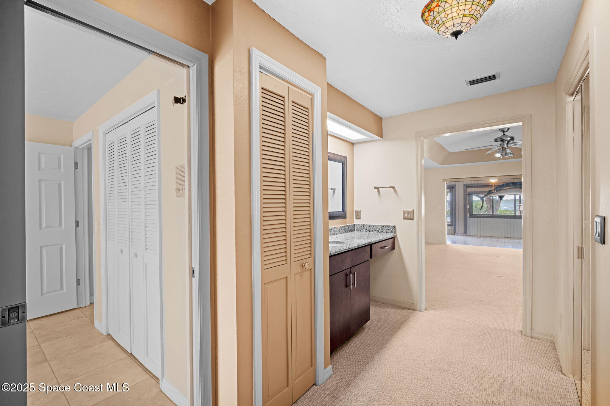 1940 Gates Road Merritt Island, FL 32952 - Photo 22 of 72 a view of a kitchen with a sink cabinet and a living room