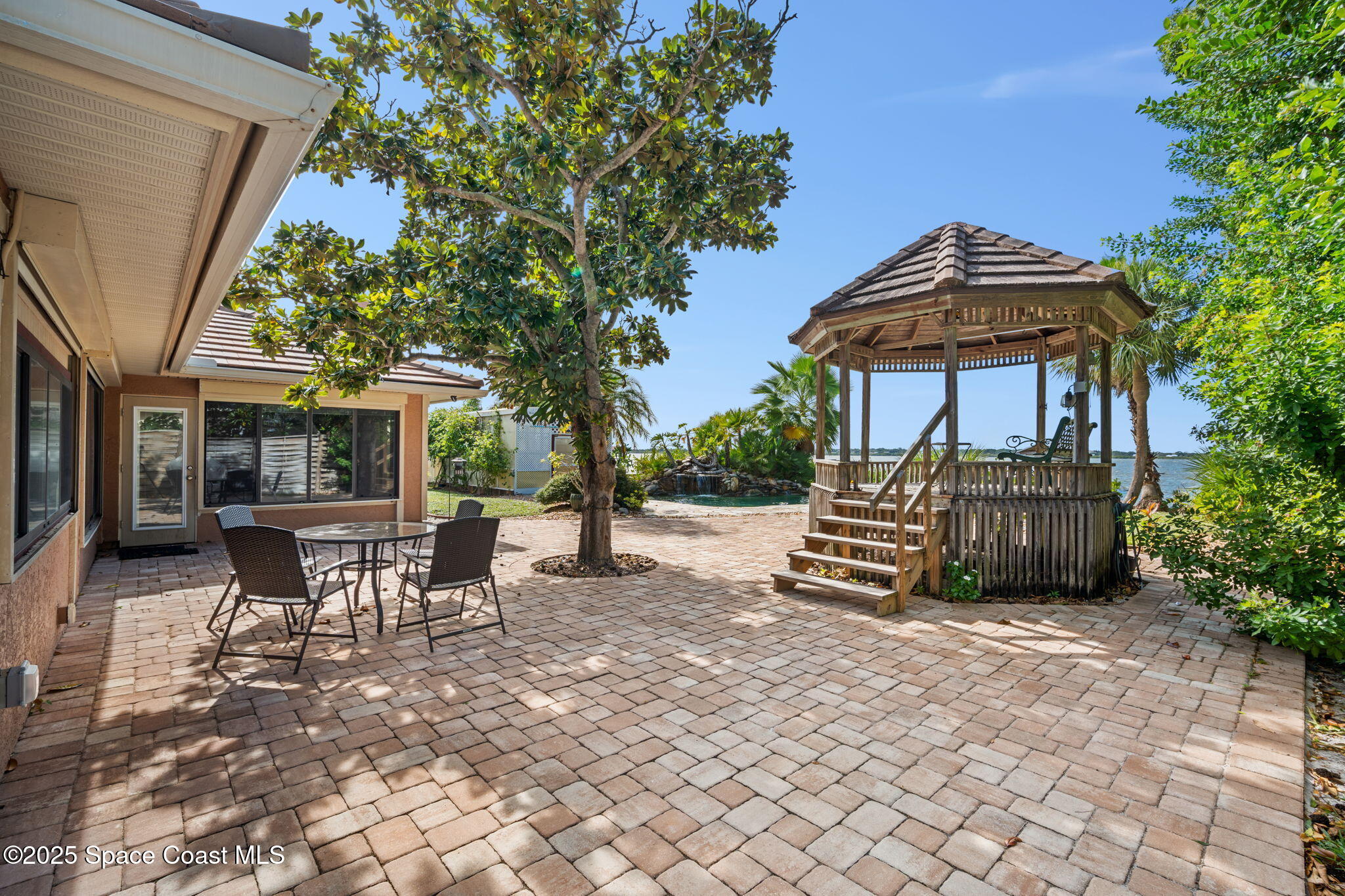 1940 Gates Road Merritt Island, FL 32952 - Photo 29 of 72 a view of a chairs and table in the back yard of the house
