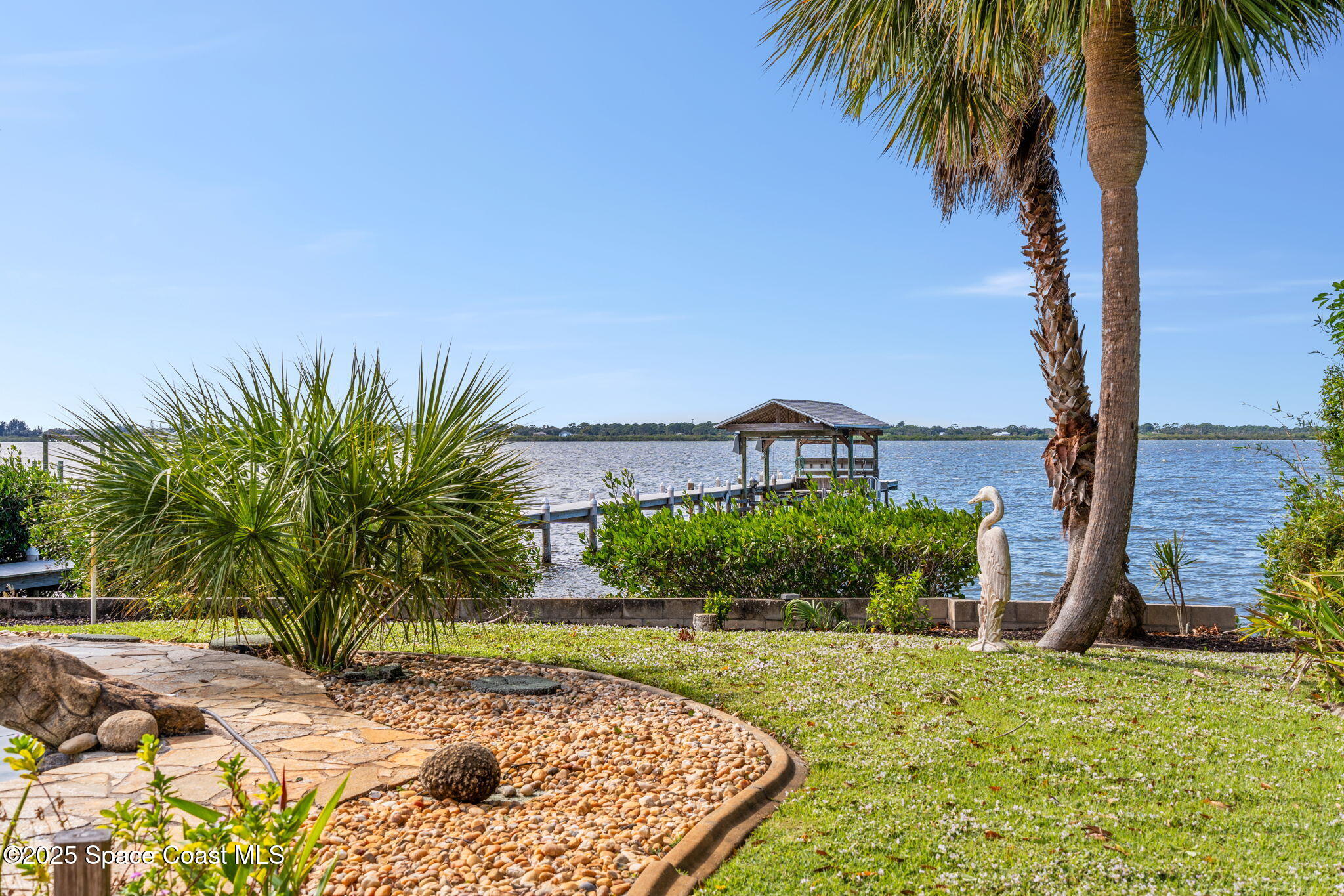 1940 Gates Road Merritt Island, FL 32952 - Photo 33 of 72 a view of a backyard with plants and palm trees
