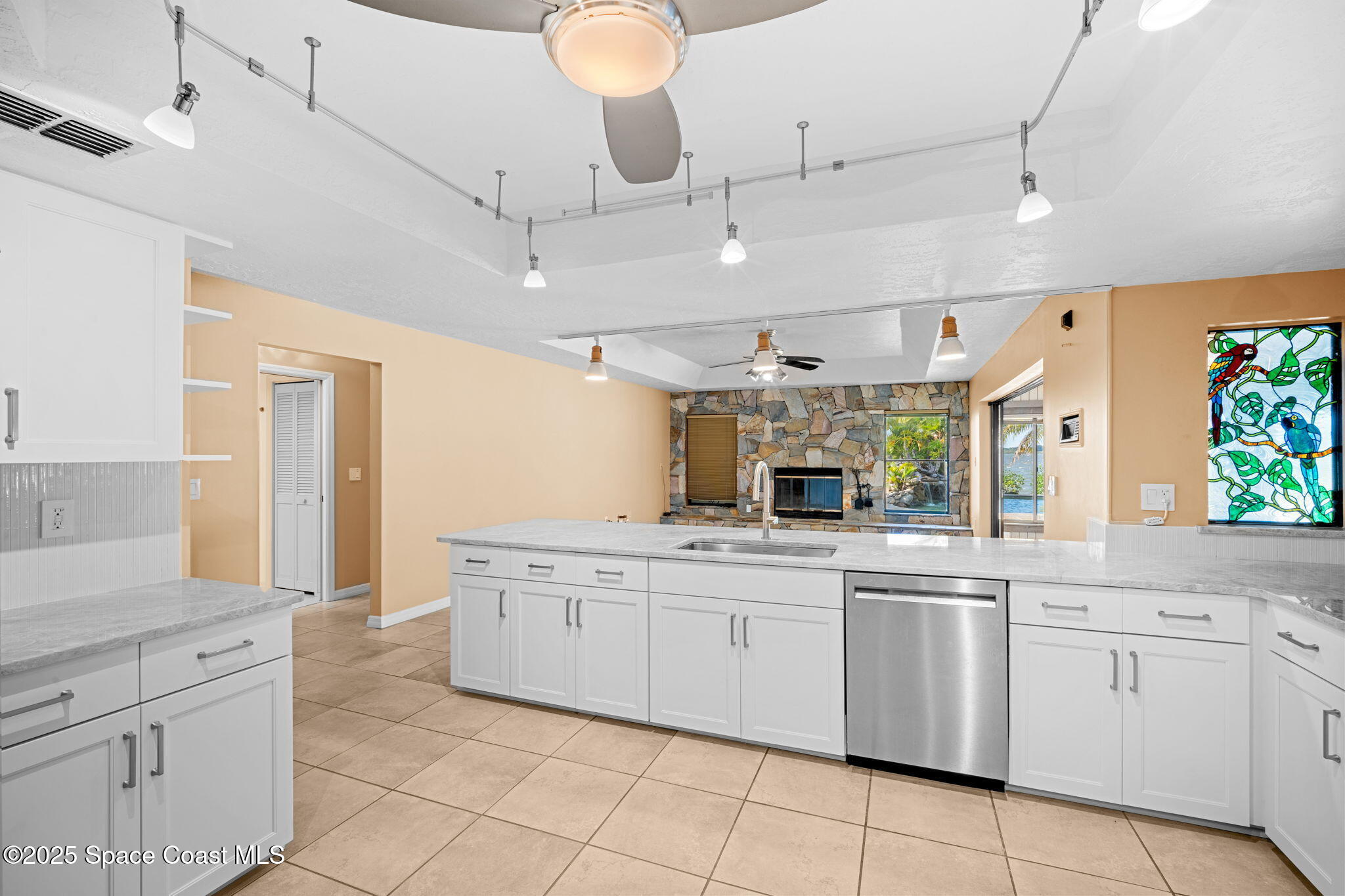 1940 Gates Road Merritt Island, FL 32952 - Photo 34 of 72 a kitchen with white cabinets appliances and a sink