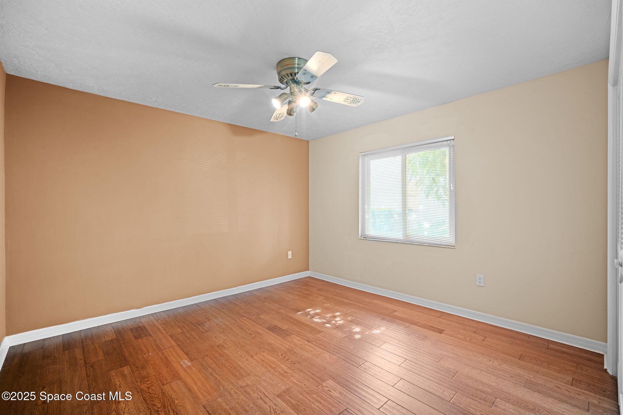 1940 Gates Road Merritt Island, FL 32952 - Photo 39 of 72 wooden floor in an empty room with a window