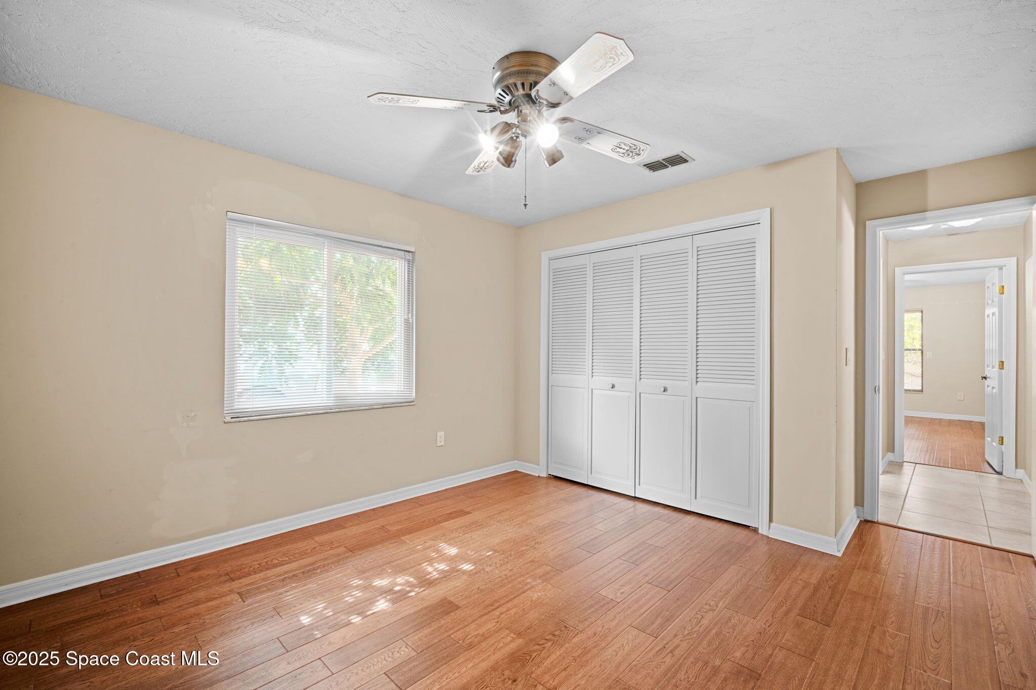 1940 Gates Road Merritt Island, FL 32952 - Photo 40 of 72 wooden floor in an empty room with a window