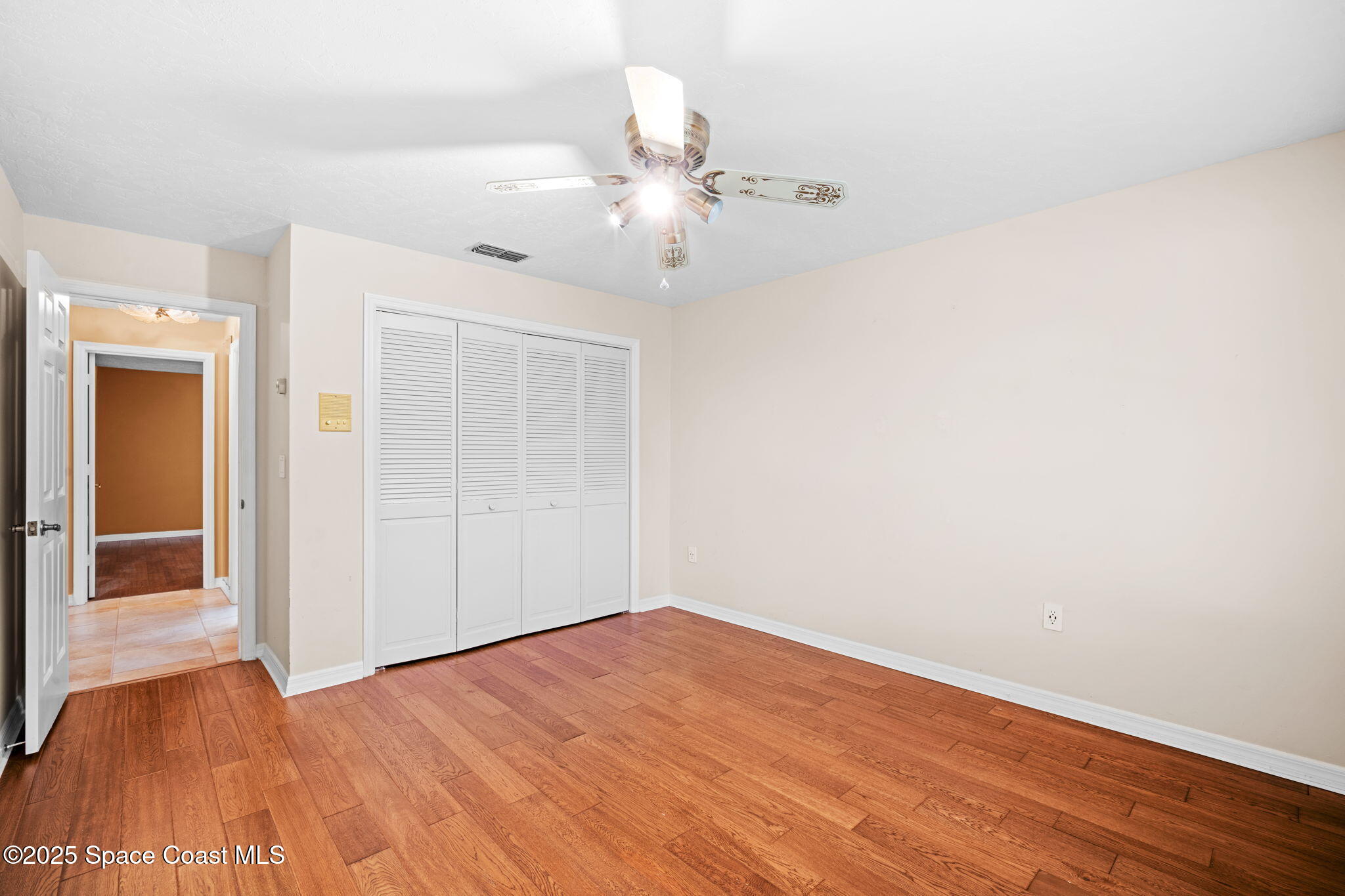 1940 Gates Road Merritt Island, FL 32952 - Photo 41 of 72 a view of an empty room with wooden floor