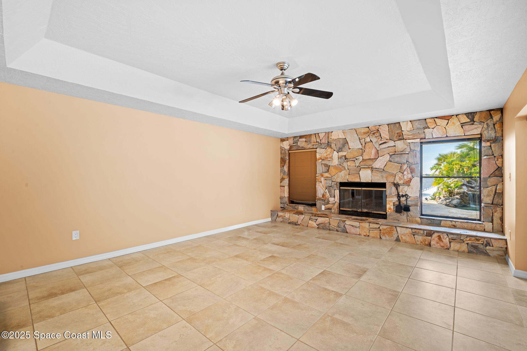 1940 Gates Road Merritt Island, FL 32952 - Photo 48 of 72 a view of an empty room with a fireplace and a window