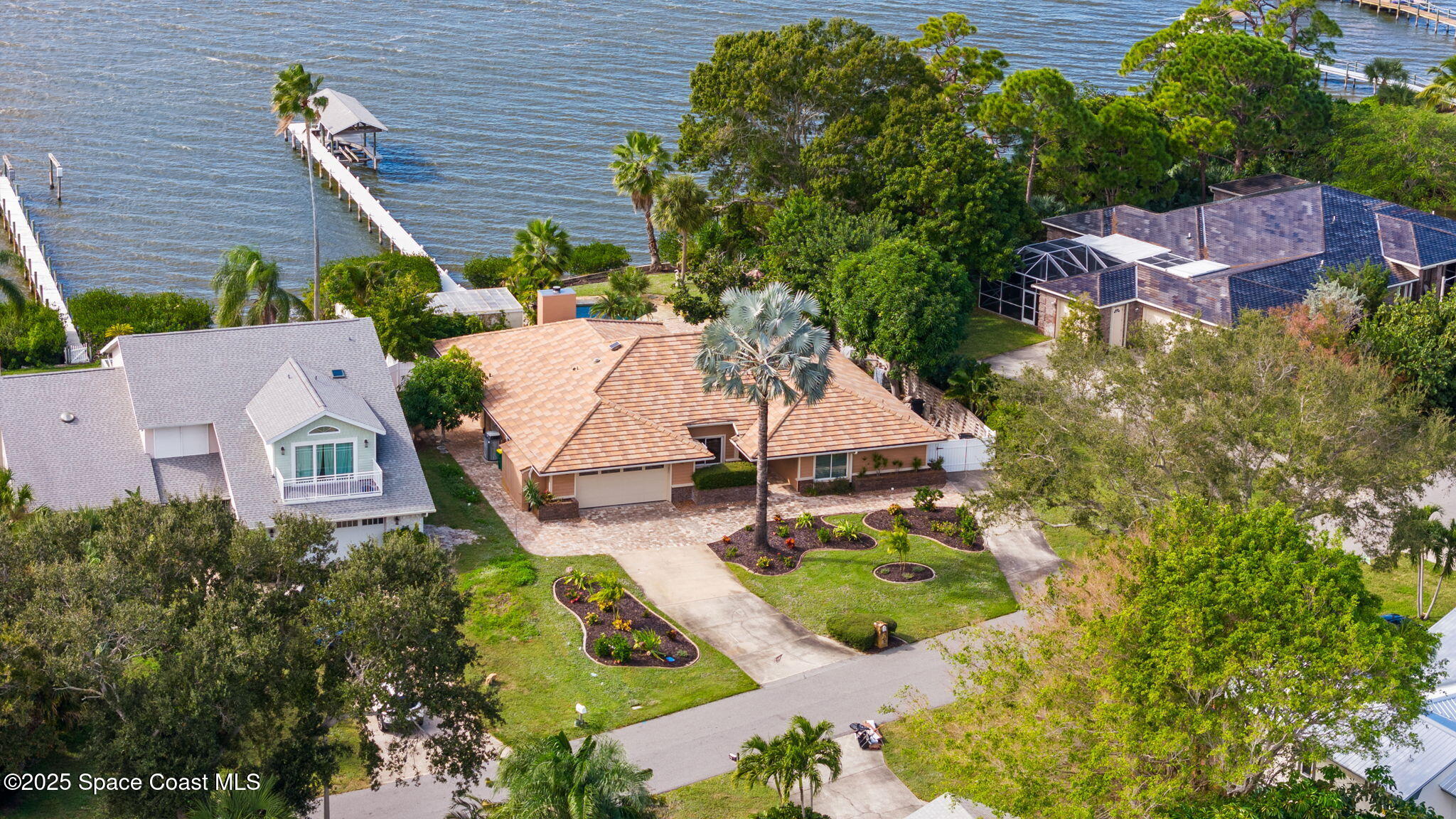 1940 Gates Road Merritt Island, FL 32952 - Photo 5 of 72 an aerial view of a house with swimming pool and glass doors