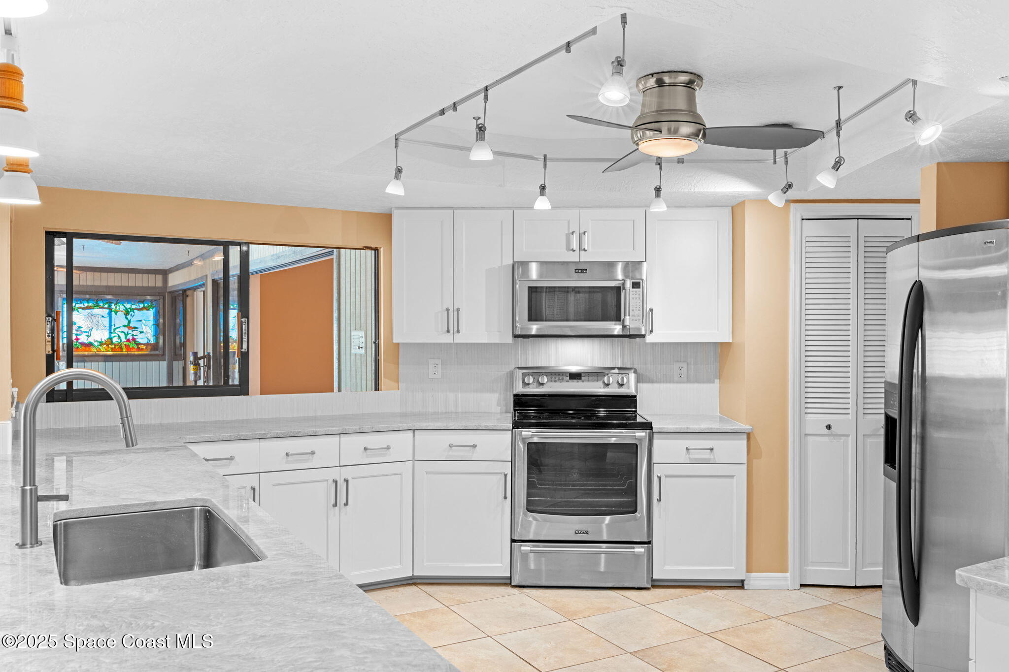 1940 Gates Road Merritt Island, FL 32952 - Photo 51 of 72 a kitchen with stainless steel appliances a stove sink and refrigerator