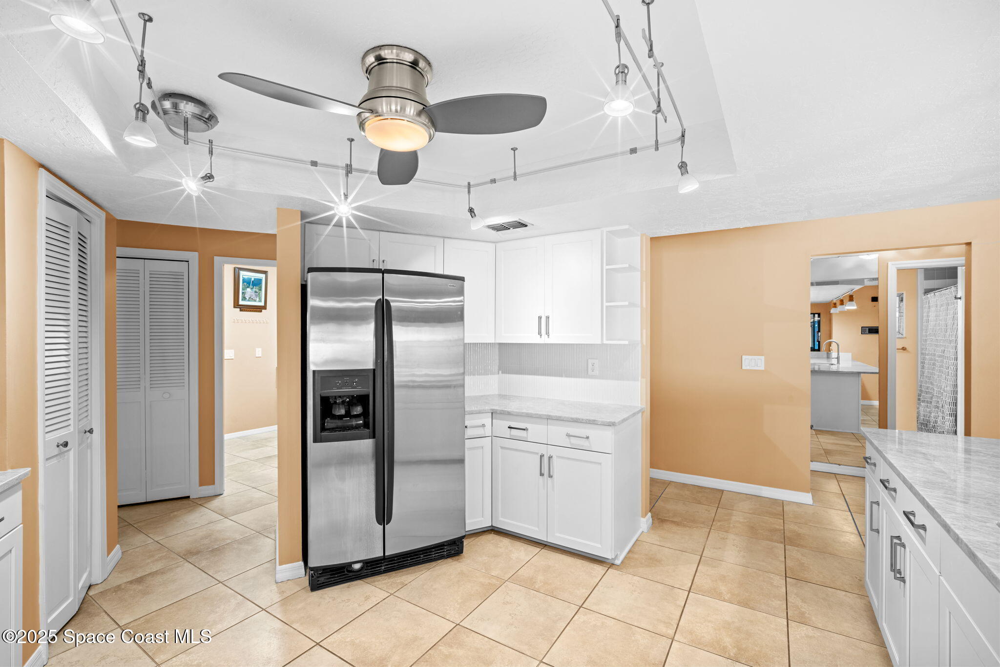 1940 Gates Road Merritt Island, FL 32952 - Photo 52 of 72 a kitchen with stainless steel appliances kitchen island granite countertop a refrigerator and a stove top oven