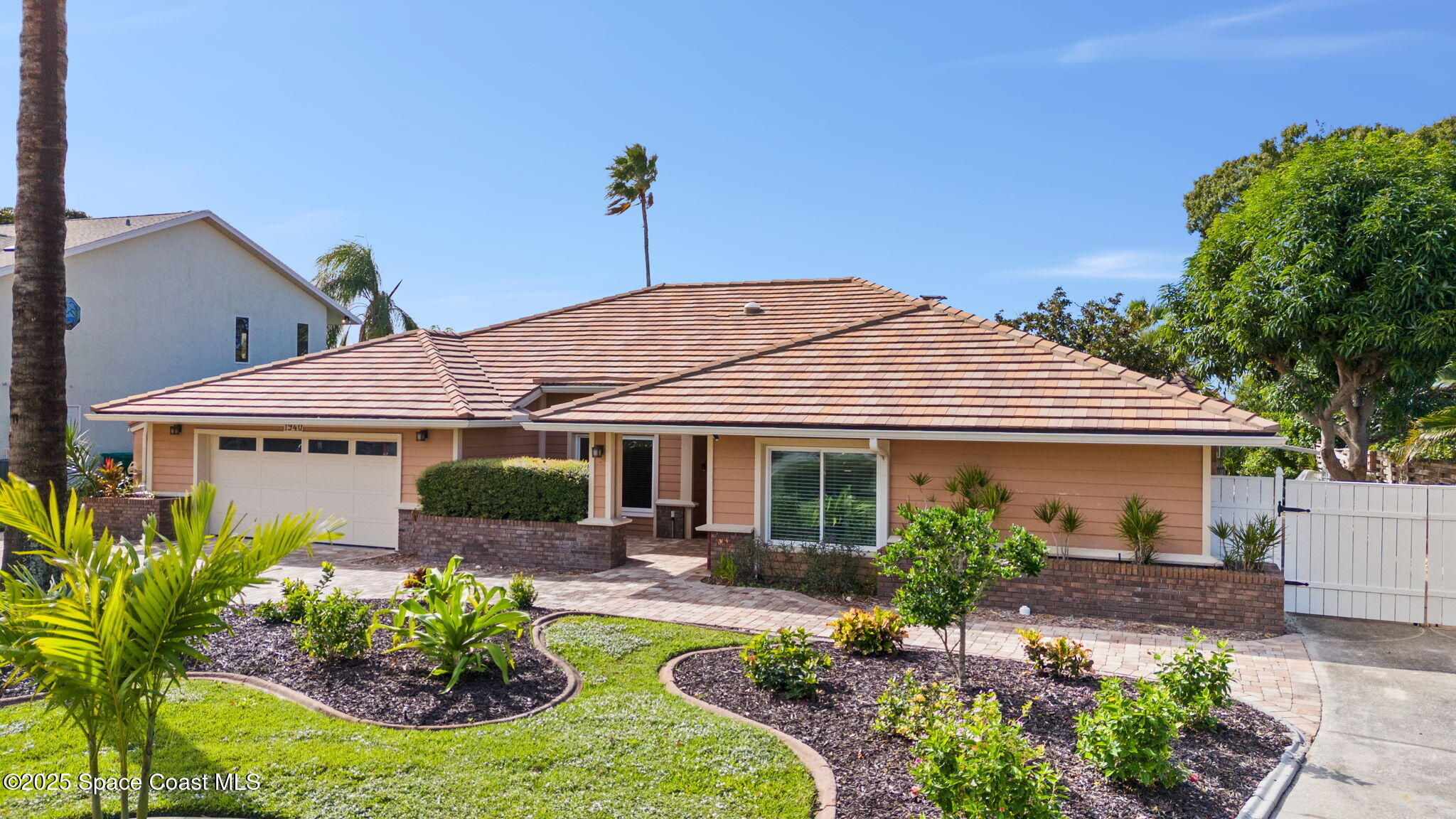 1940 Gates Road Merritt Island, FL 32952 - Photo 55 of 72 a front view of a house with a yard and potted plants