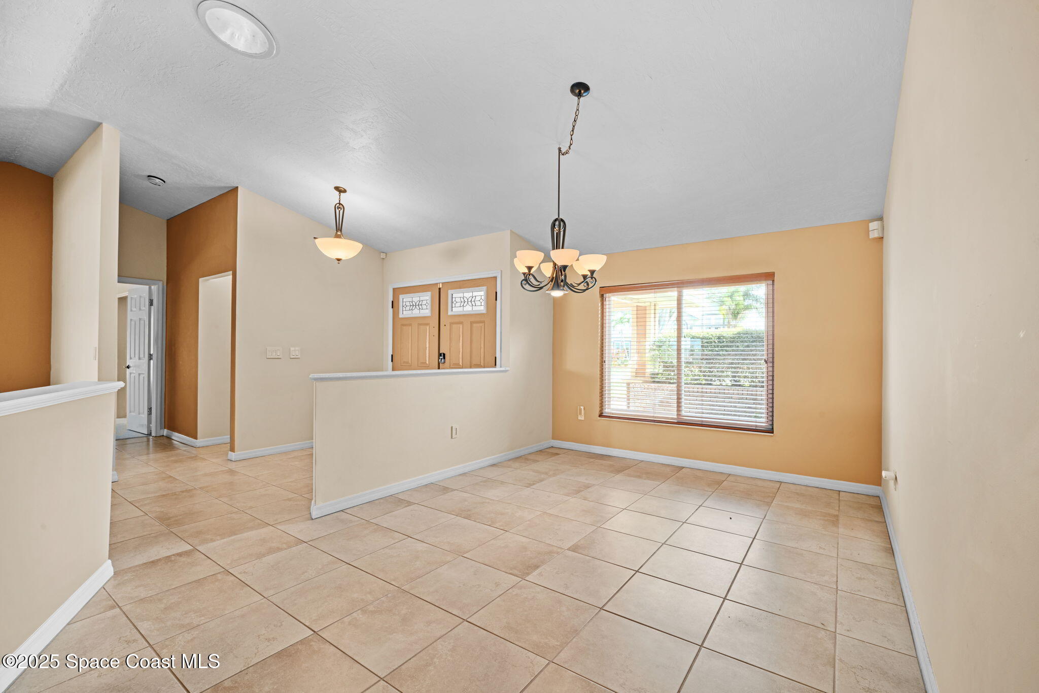 1940 Gates Road Merritt Island, FL 32952 - Photo 61 of 72 a view of an empty room with window and chandelier fan