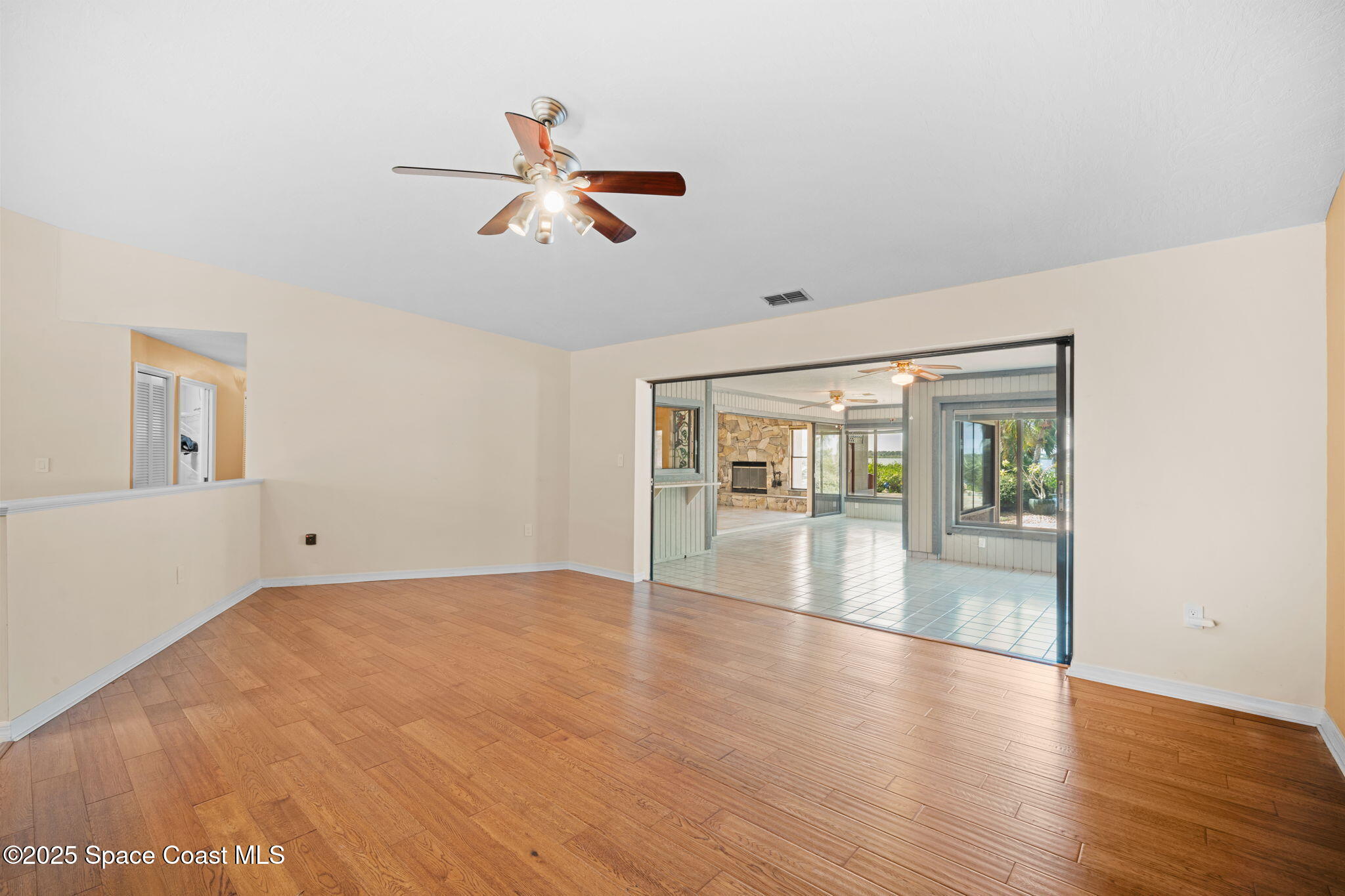 1940 Gates Road Merritt Island, FL 32952 - Photo 64 of 72 a view of empty room with wooden floor and fan