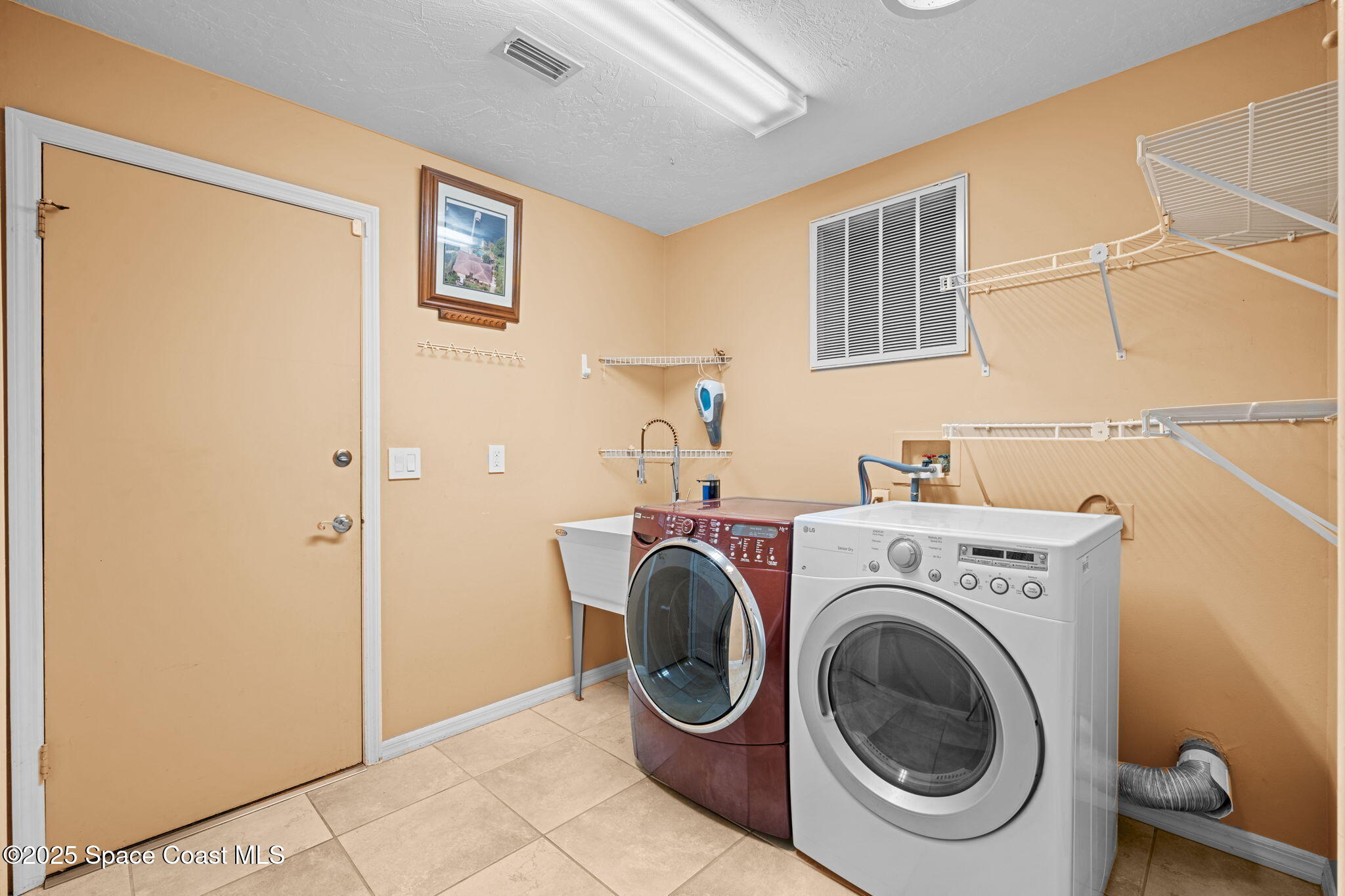 1940 Gates Road Merritt Island, FL 32952 - Photo 68 of 72 a utility room with dryer and washer