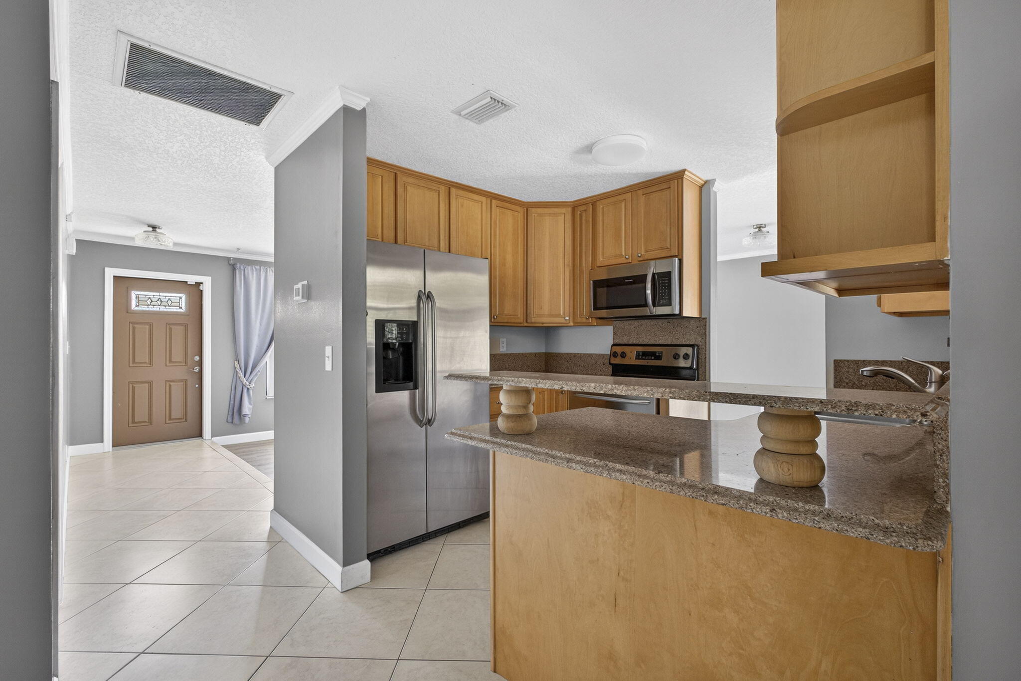 7107 181st Street Jupiter, FL 33458 - Photo 15 of 54 a kitchen with a refrigerator sink and microwave
