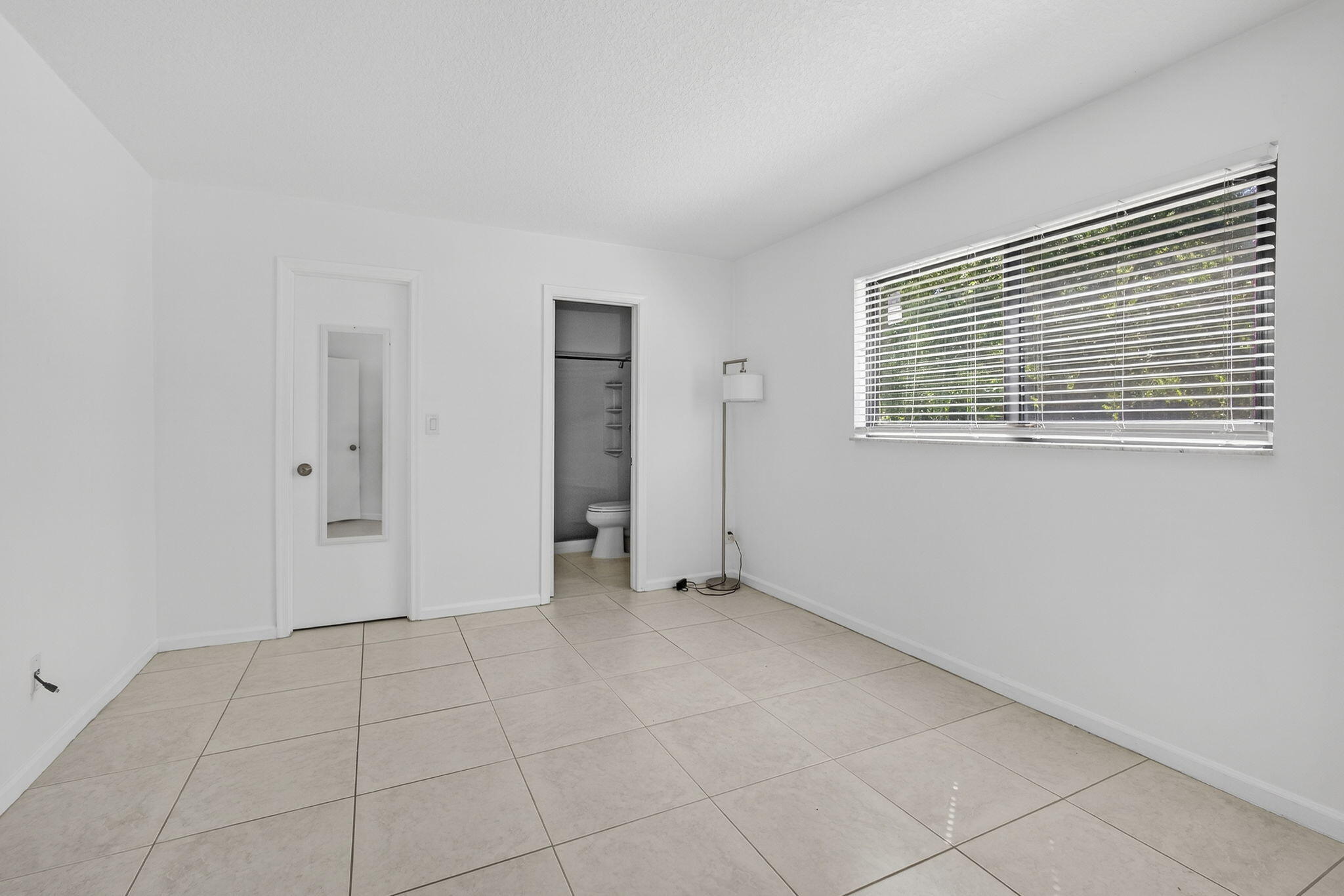 7107 181st Street Jupiter, FL 33458 - Photo 16 of 54 a view of an empty room with a window