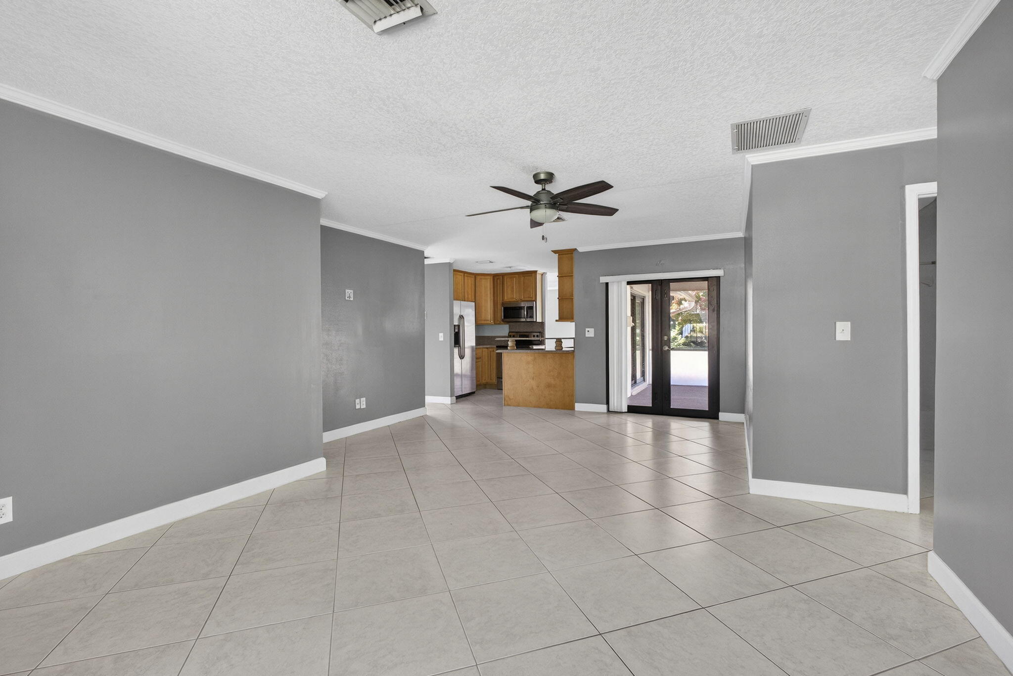 7107 181st Street Jupiter, FL 33458 - Photo 18 of 54 a view of a livingroom with a chandelier fan and windows