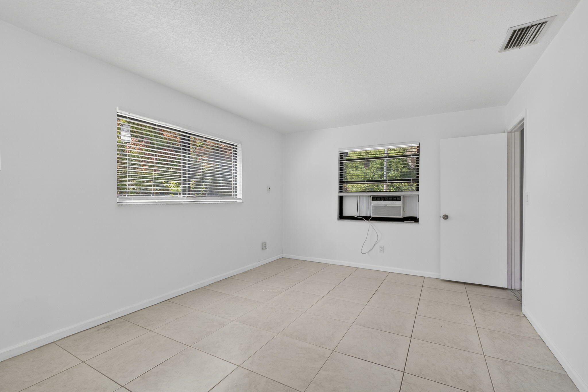 7107 181st Street Jupiter, FL 33458 - Photo 20 of 54 a view of an empty room with a window