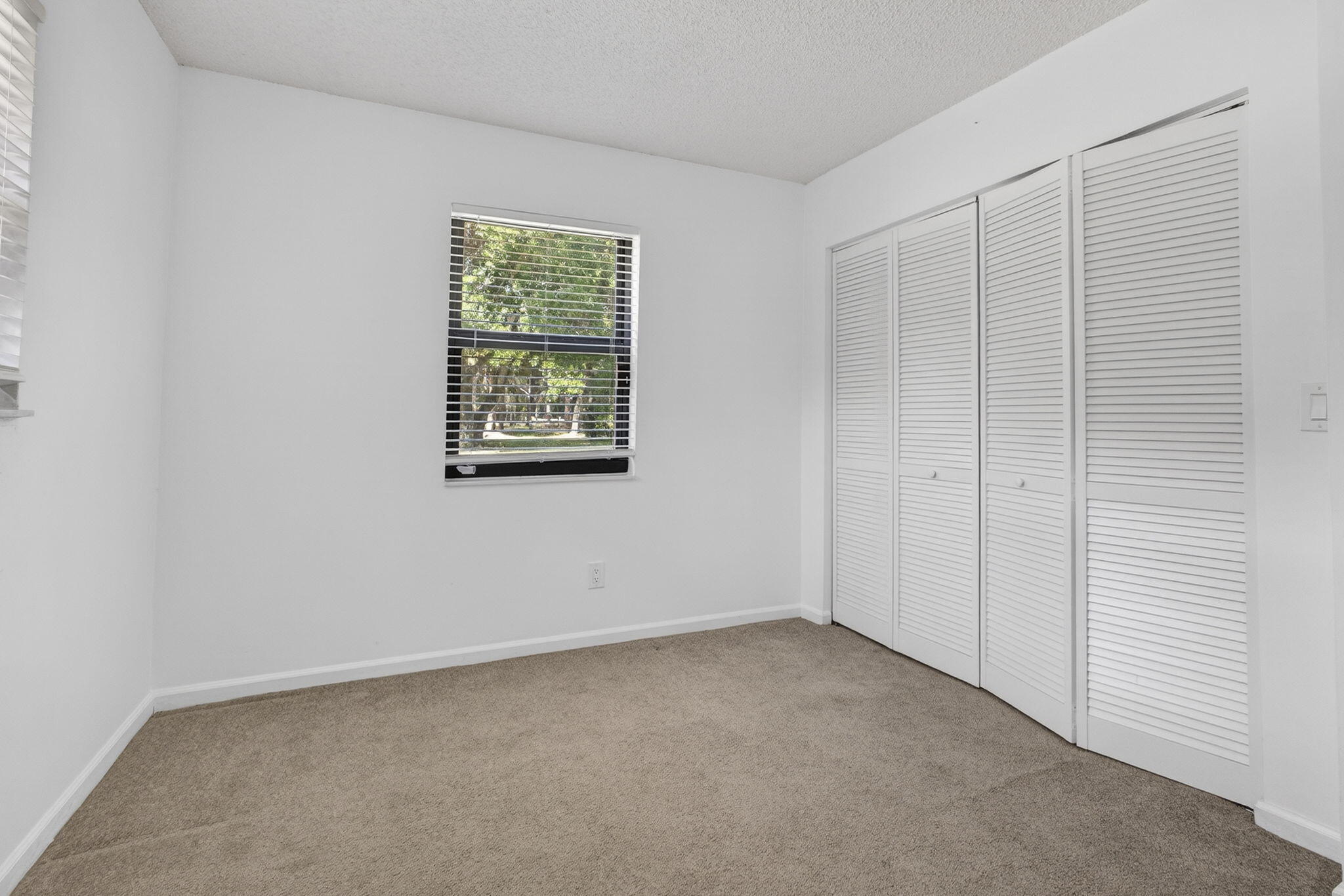 7107 181st Street Jupiter, FL 33458 - Photo 28 of 54 an empty room with windows