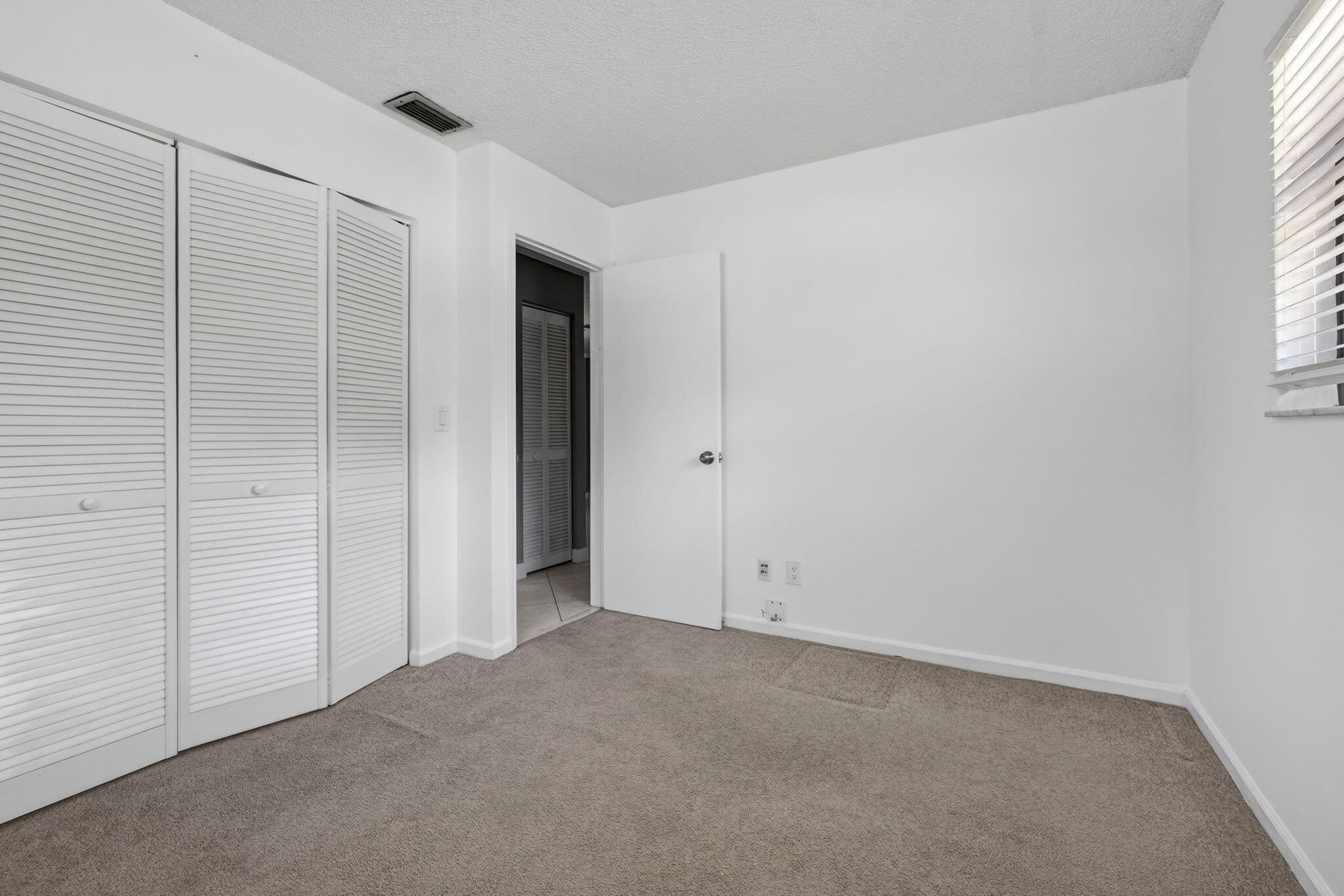 7107 181st Street Jupiter, FL 33458 - Photo 29 of 54 an empty room with windows